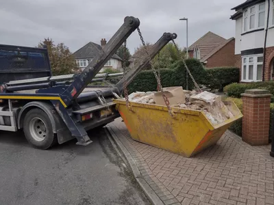 A skip filled with waste, ready for collection